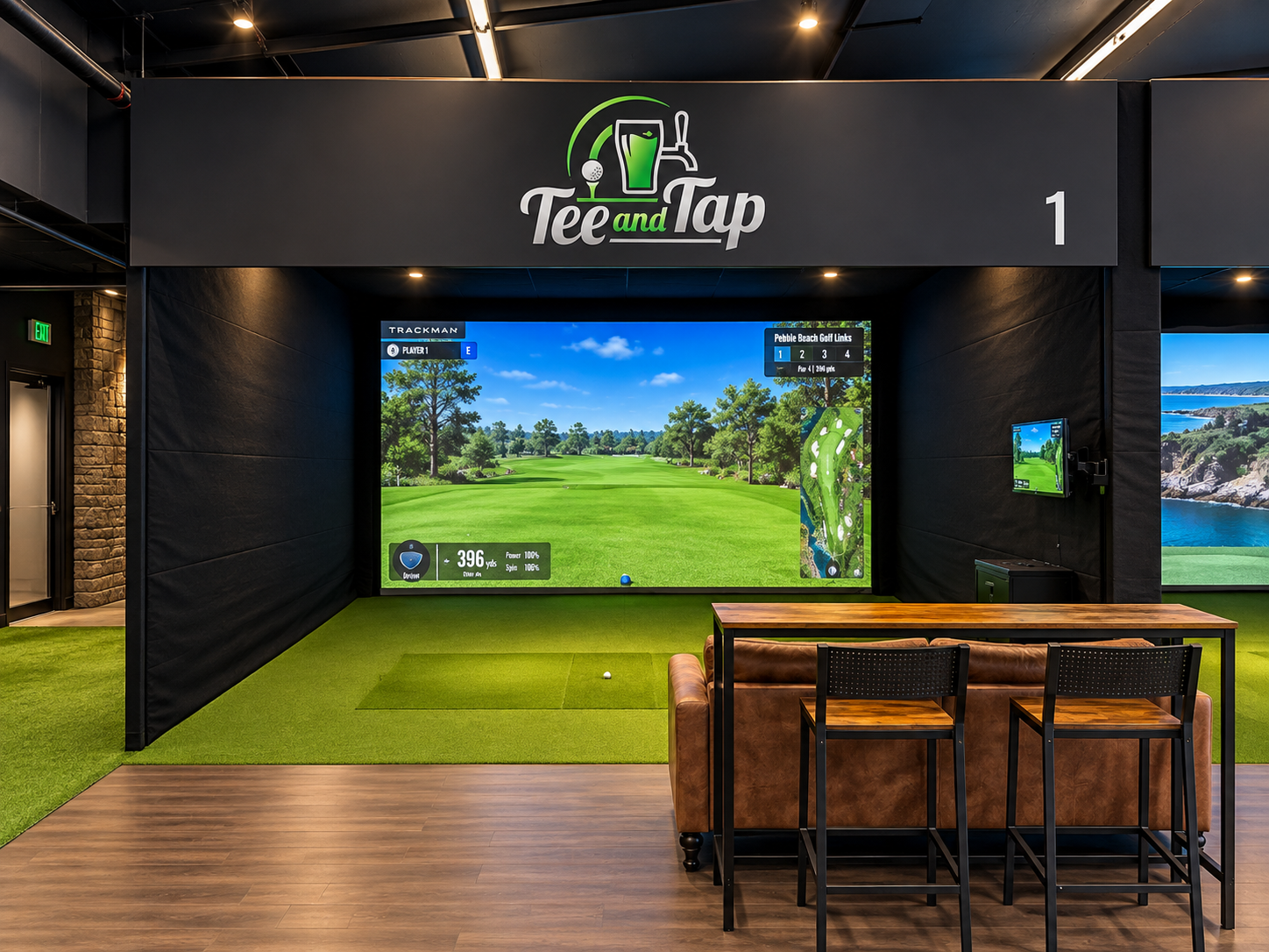 Tee and Tap simulator bay 1 with branded header, Trackman screen and lounge seating